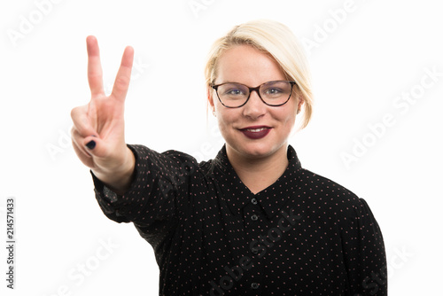Young blonde female teacher wearing glasses showing victory gesture