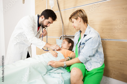 Doctor checking her patient heart in hospital 