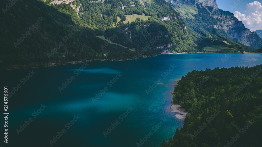 aerial view of deep blue mountain lake in swiss alps, klontalersee switzerland