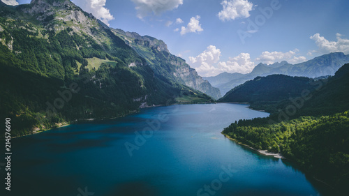aerial view of deep blue mountain lake in swiss alps, klontalersee switzerland