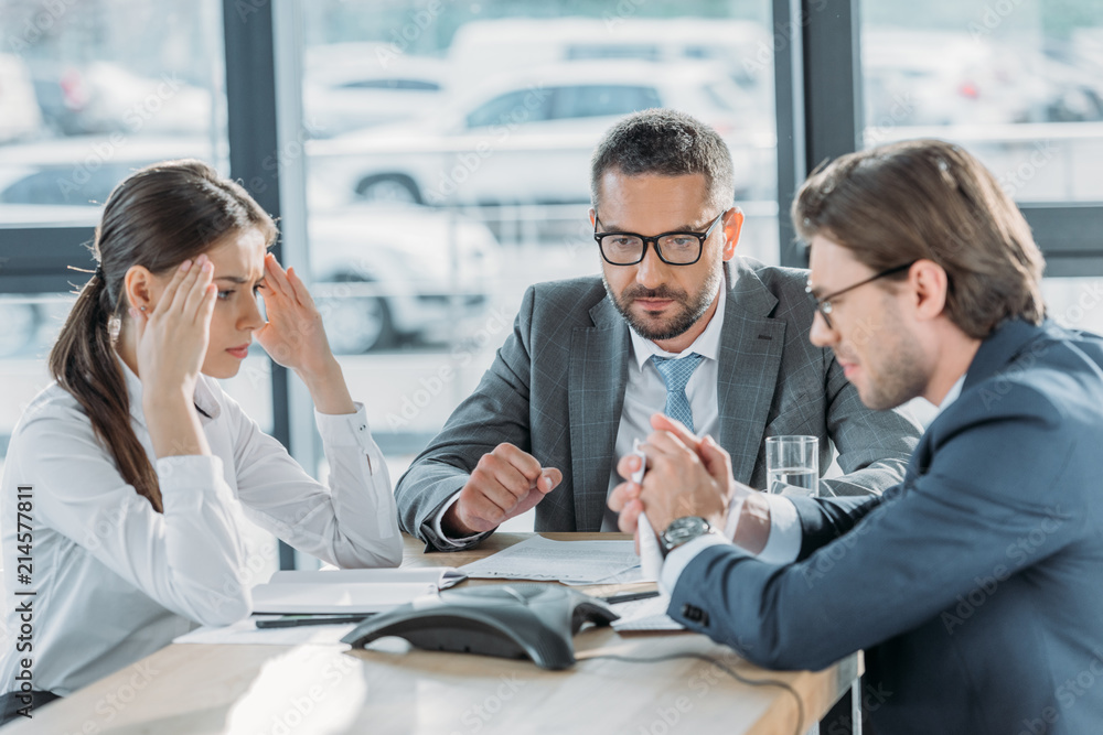 Fototapeta premium serious business people having conversation and using speakerphone at modern office