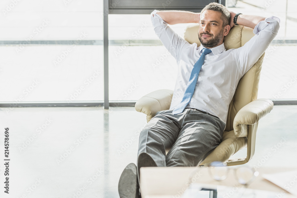handsome businessman relaxing on luxury armchair at modern office handsome businessman relaxing on luxury armchair at modern office
