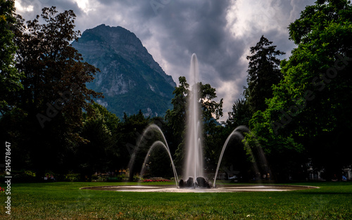 fountain infront of big mountain scenery in glarus, switzerland