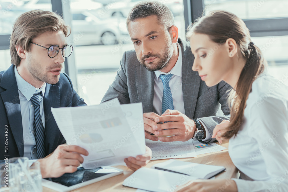 business people doing paperwork together at modern office business people doing paperwork together at modern office