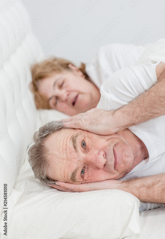 senior man who can not sleep because his wife snores senior man who can not sleep because his wife snores