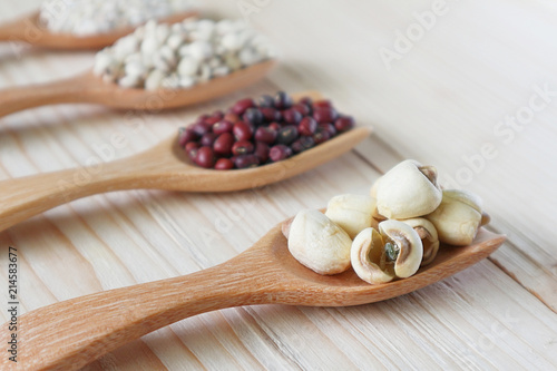 Dry millet seed with blur mix cereal on wood table. photo