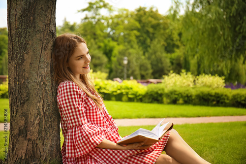Young woman reading book wh...