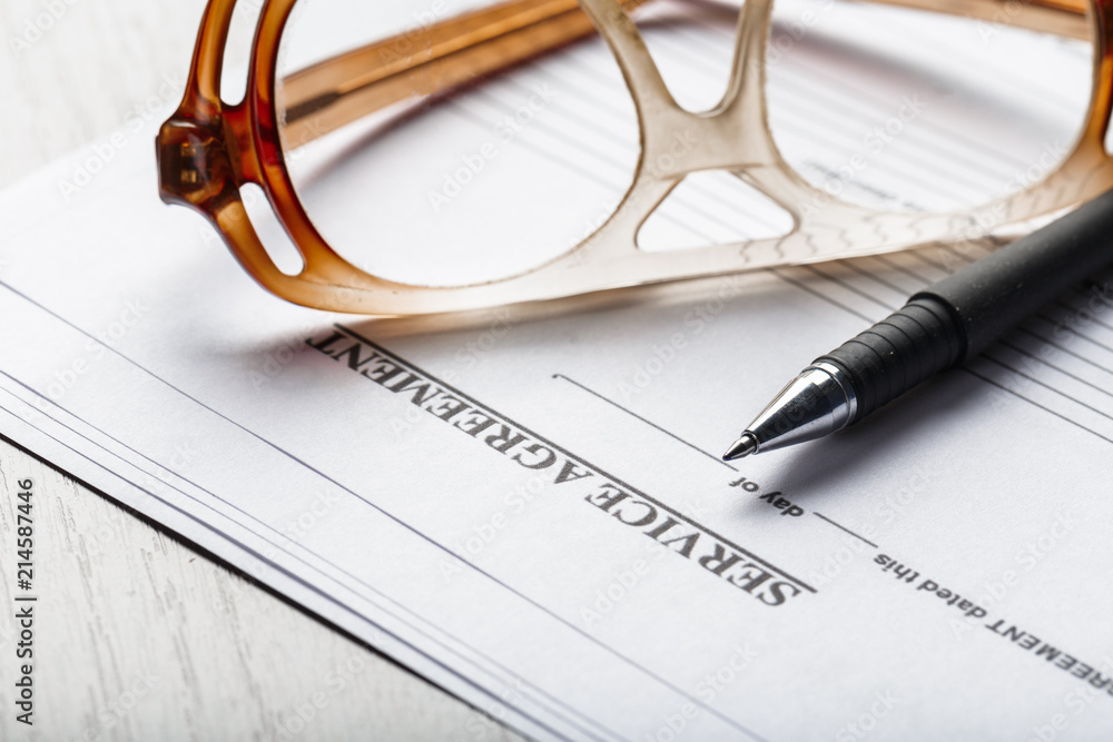 Close up shot of Eyeglasses on contract document papers business concept Close up shot of Eyeglasses on contract document papers business concept
