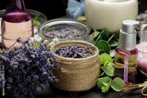 Aromatic composition of lavender, herbs, cosmetics and salt on a dark table top