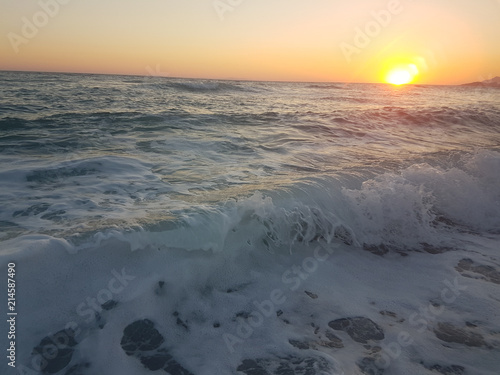 sunset sea waves foam splash  in summer Preveza Vrahos Greece