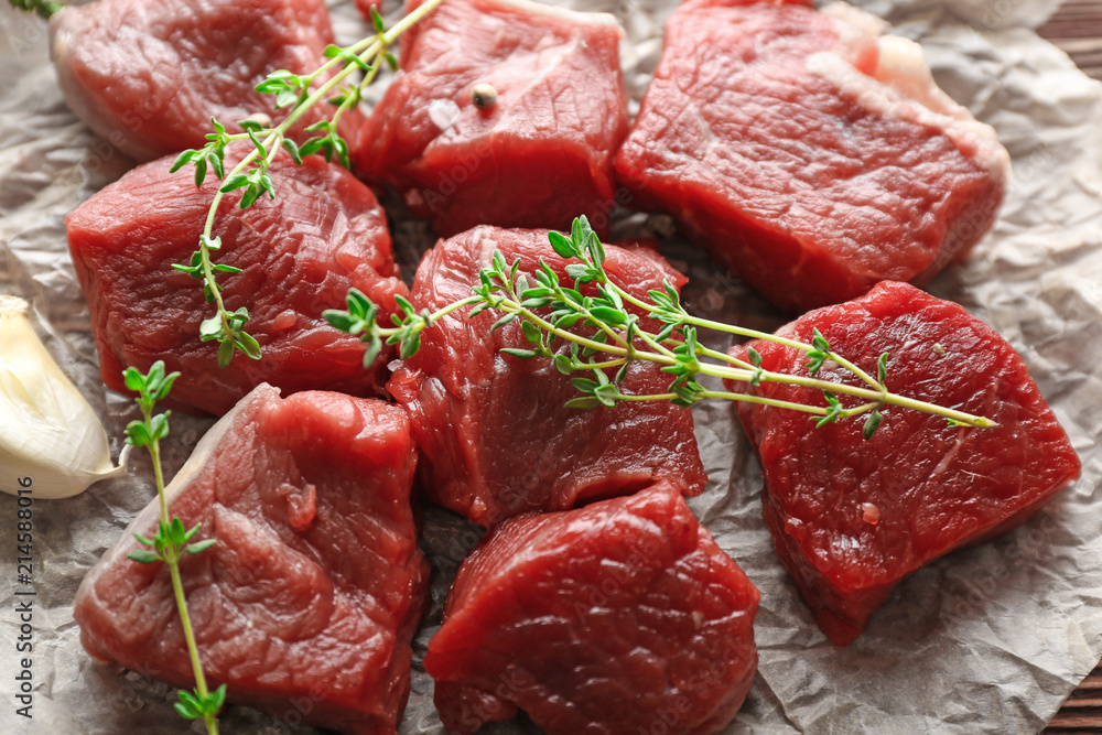 Pieces of raw meat with spices on table