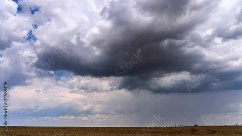 Time lapse footage of approaching storm with heavy clouds on blue sky background.