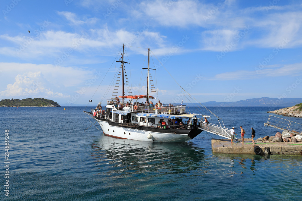 A pleasure cruise ship stands at the pier of the Kassandra Peninsula A pleasure cruise ship stands at the pier of the Kassandra Peninsula
