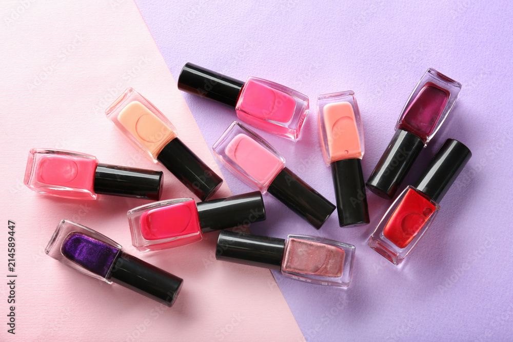 Bottles of nail polishes on color background Bottles of nail polishes on color background