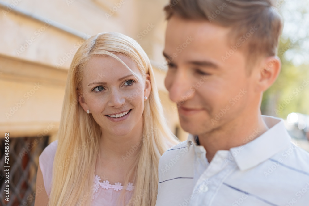 Pretty young wife watching her husband closely Pretty young wife watching her husband closely