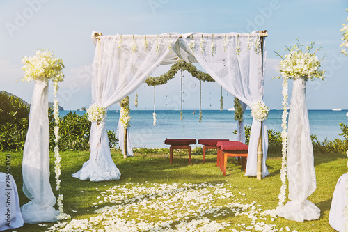 Beautiful beach wedding flower arch setting for wedding venue with panoramic ocean view