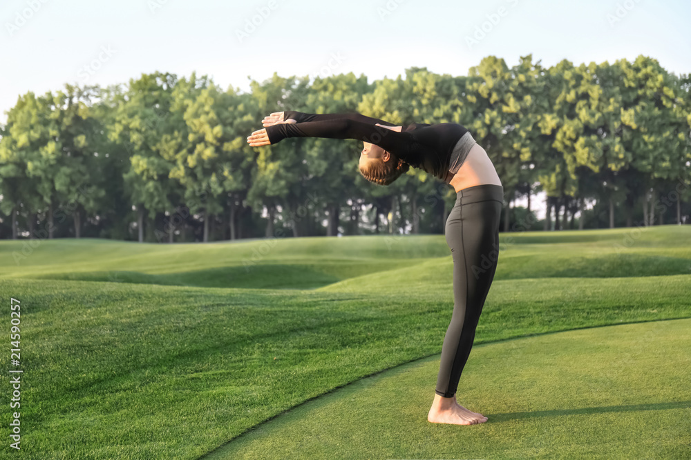 Beautiful young woman practicing yoga outdoors in the morning Beautiful young woman practicing yoga outdoors in the morning