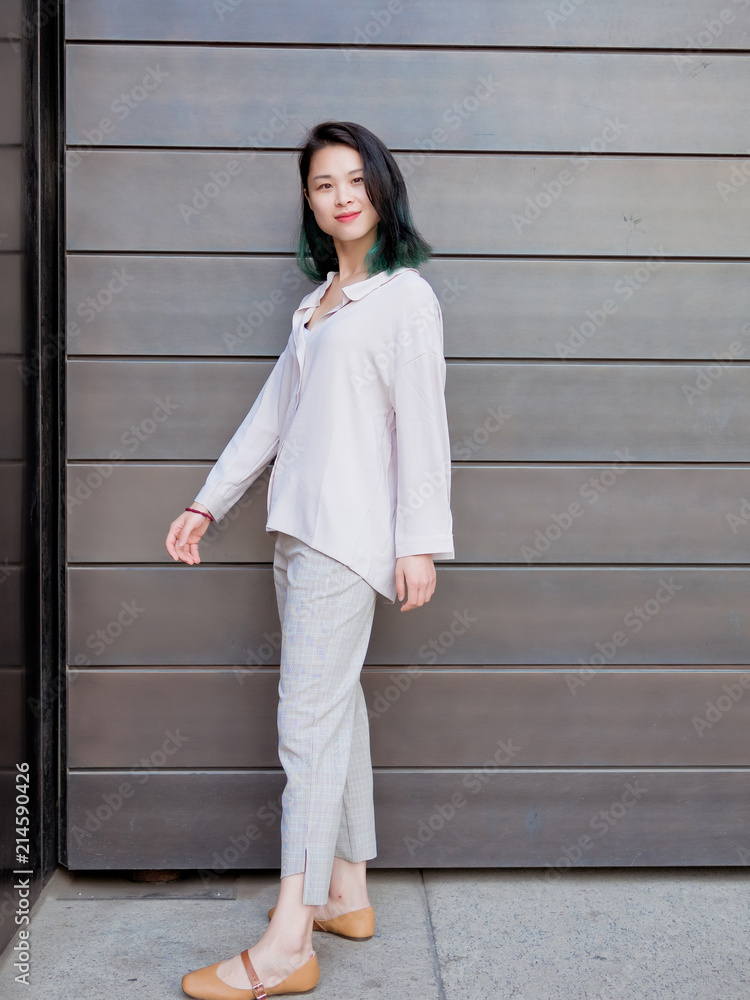 Fototapeta premium Beautiful young girl with green hair posing outdoor. Sunny portrait of glamour Chinese stylish lady. Emotions, people, beauty and lifestyle concept.