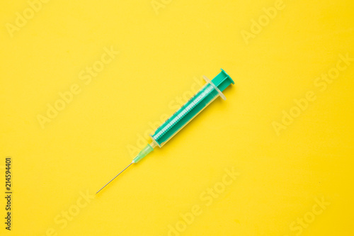 Medical syringe on colorful background.