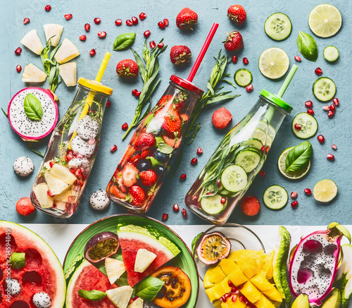 Fotografie Summer refreshing and extra hydrating infused water in bottles with ingredients, top view