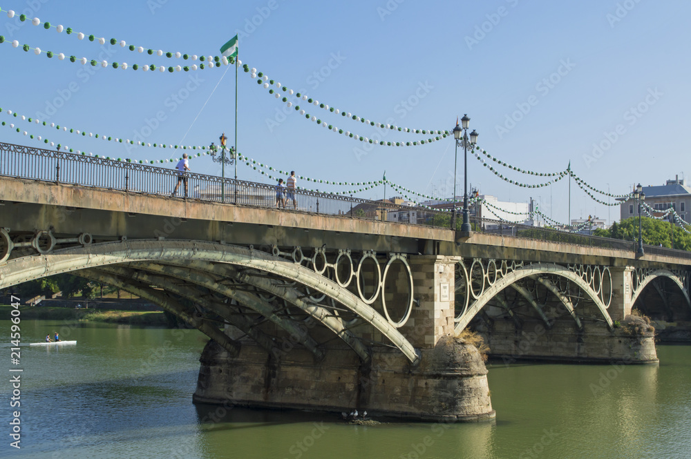 Fototapeta premium Puente de Isabel II con farolillos para la Velá de Santa Ana / Bridge of Isabel II with Chinese lanterns for the Velá of Holy Ana. Triana, Sevilla
