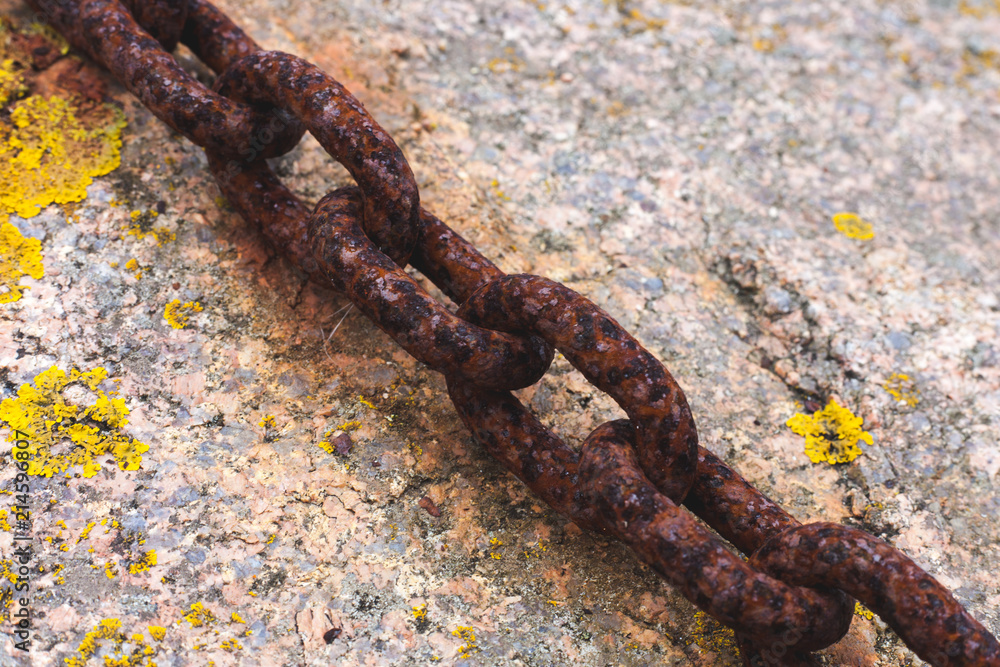 Rusty chain on granite background Rusty chain on granite background