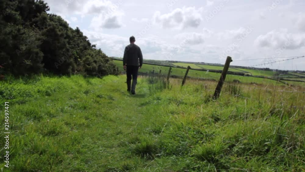 Farmer walking his land in England. Farmer walking his land in England.