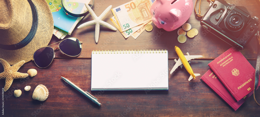 Fototapeta premium Travel accessories, passports, luggage, the cost of travel maps prepared for the trip on wooden table