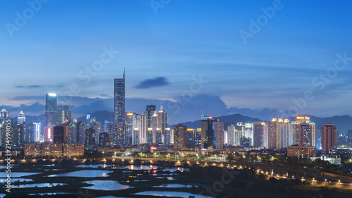 Skyline of Shenzhen City, China at twilight. Viewed from Hong Kong border © leeyiutung