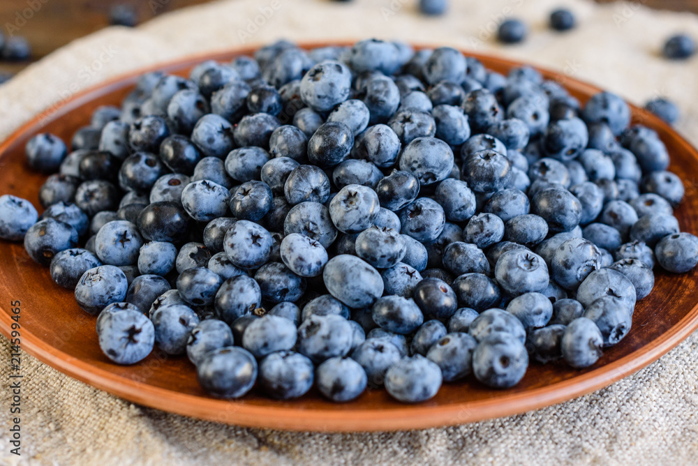 Fresh berries of blueberry on a plate. It can be used as a background Fresh berries of blueberry on a plate. It can be used as a background