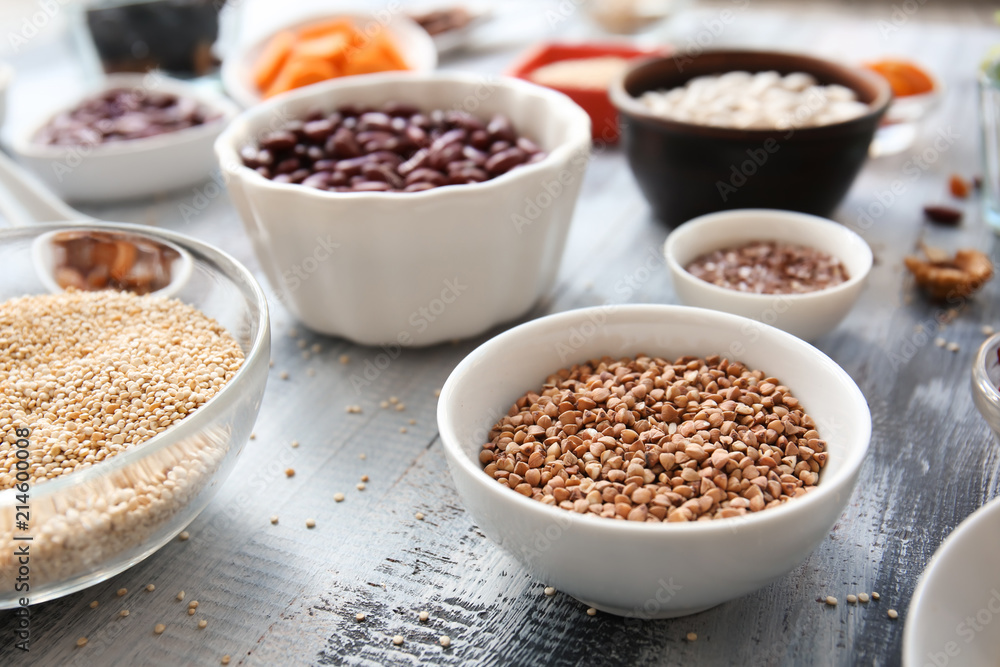Bowls with various healthy products on wooden table Bowls with various healthy products on wooden table