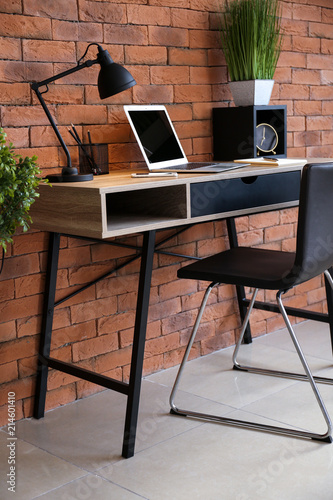 Stylish workplace with lapt...