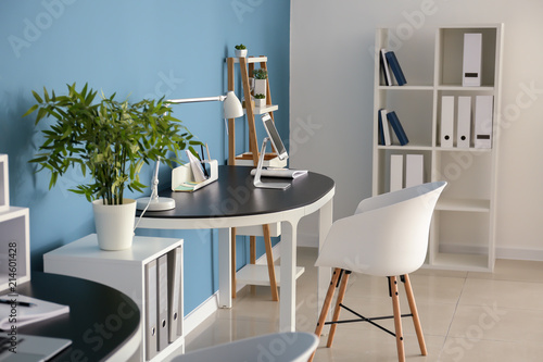 Stylish workplace with tabl...