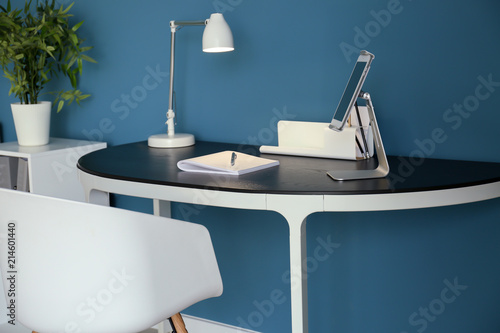 Stylish workplace with tabl...