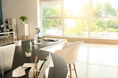Stylish workplace with tabl...