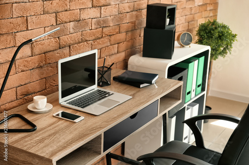 Stylish workplace with lapt...