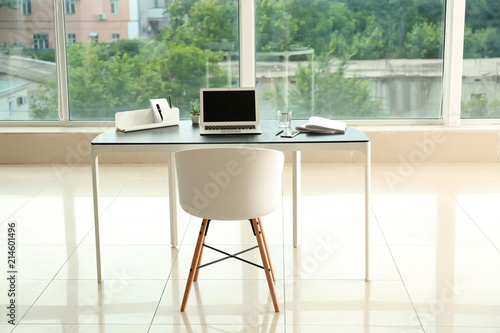 Stylish workplace with lapt...