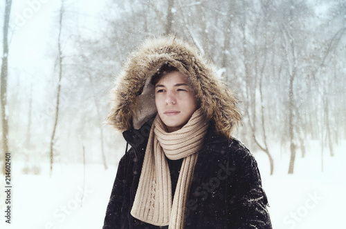 young man in hood in the park in winter