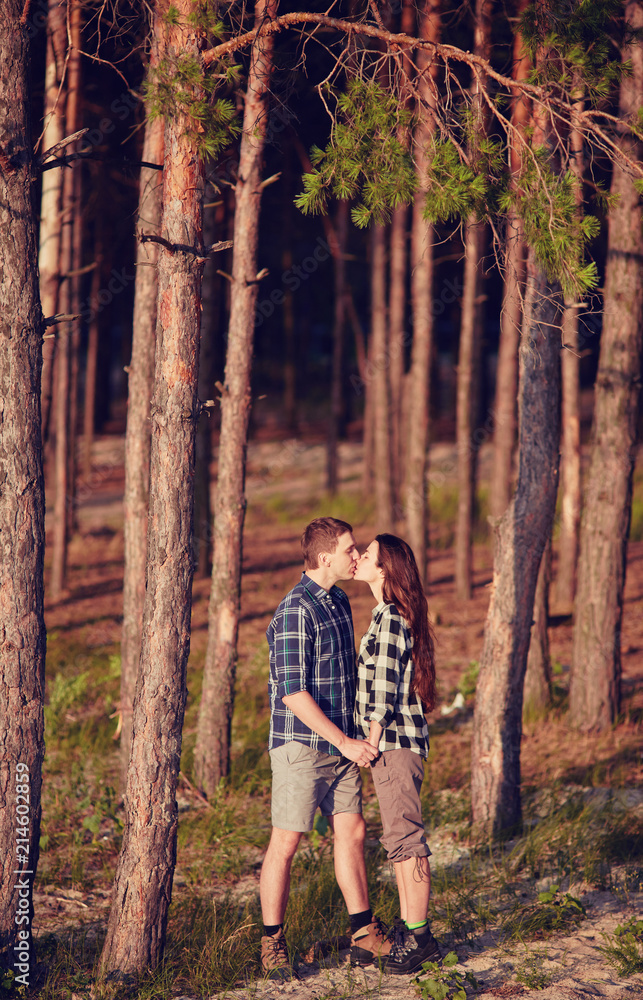young couple smiling at each other during a romantic date in the forest young couple smiling at each other during a romantic date in the forest