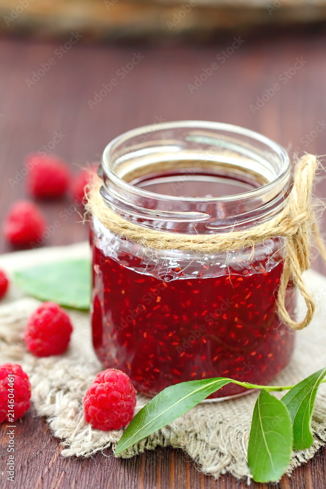 Raspberry jam in a jur and fresh berries on the table Raspberry jam in a jur and fresh berries on the table