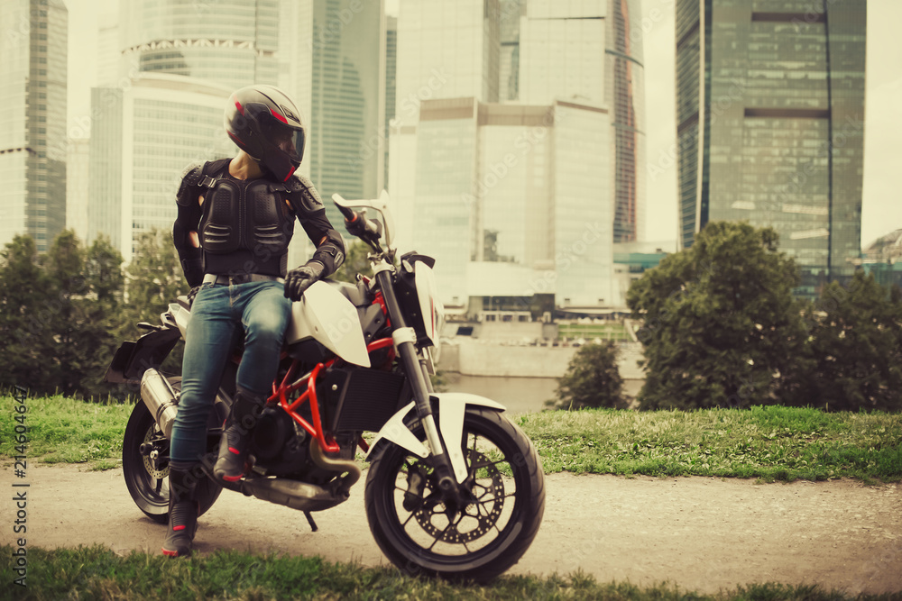 Biker and motorcycle near downtown city urban district Biker and motorcycle near downtown city urban district
