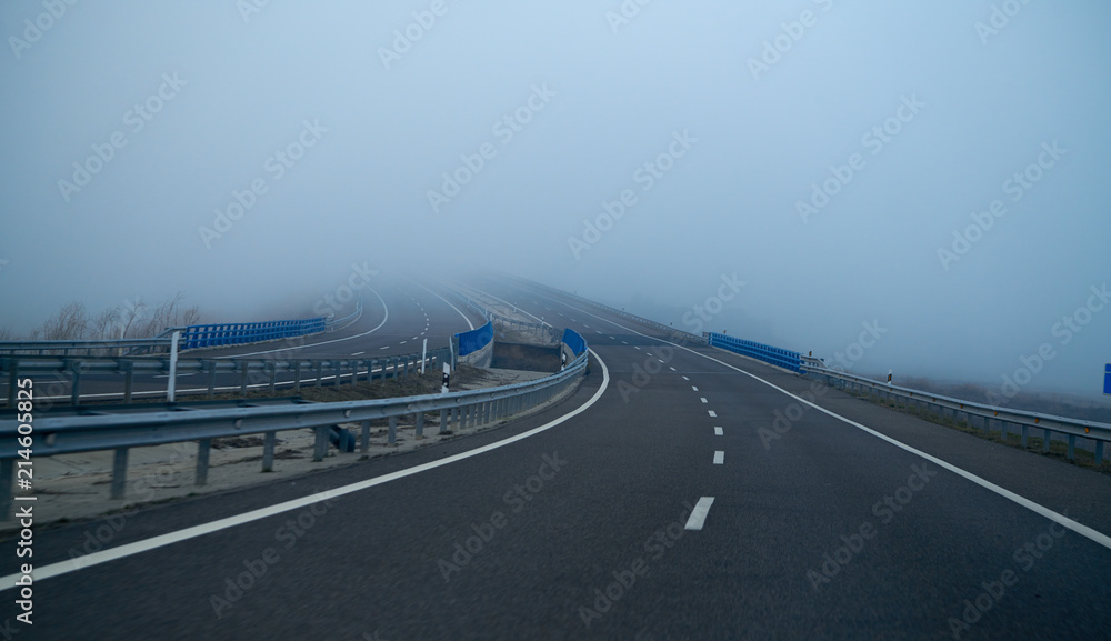 Fototapeta premium Foggy road with fog in horizon