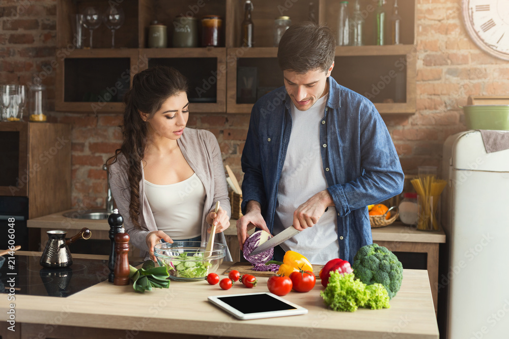Fotografie Happy couple cooking healthy food together