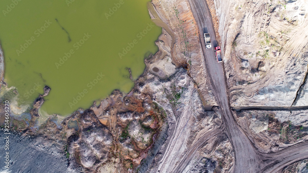Fototapeta premium Aerial view on open pit mine of sand, hummus and coal, flooded with water
