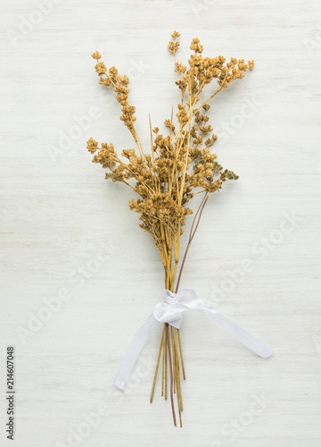 Beautiful Autumnal Easter Wedding Background. Dry Wild Flowers Tied with Silk Ribbon on White Wood. Minimalist Japanese Style. Elegant Female Styled Stock Image for Website Blog Social Media photo