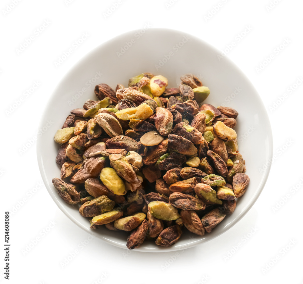 Bowl with tasty pistachio nuts on white background Bowl with tasty pistachio nuts on white background