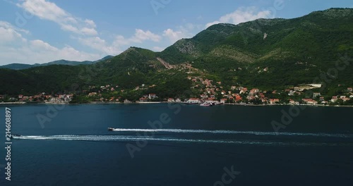 Aerial beautiful view from above to Kotor Bay and regular passenger ferry from Lepetane to Kamenari by a sunny afternoon photo