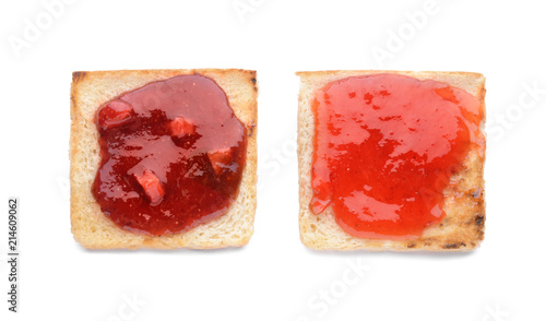 Toasts with tasty strawberry jam on white background