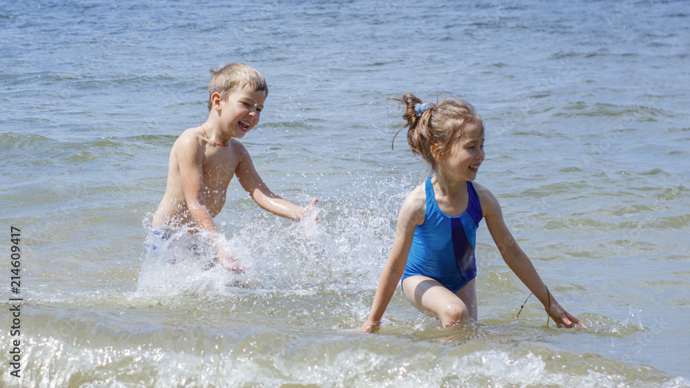 Children have fun playing on the seashore Children have fun playing on the seashore