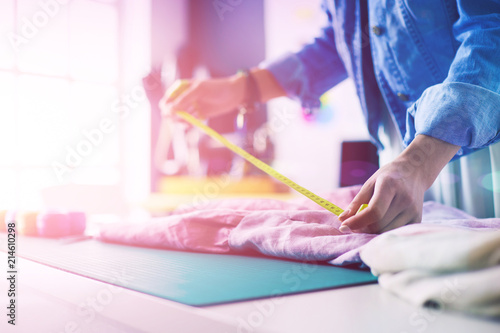 Fashion designer woman working on her designs in the studio photo